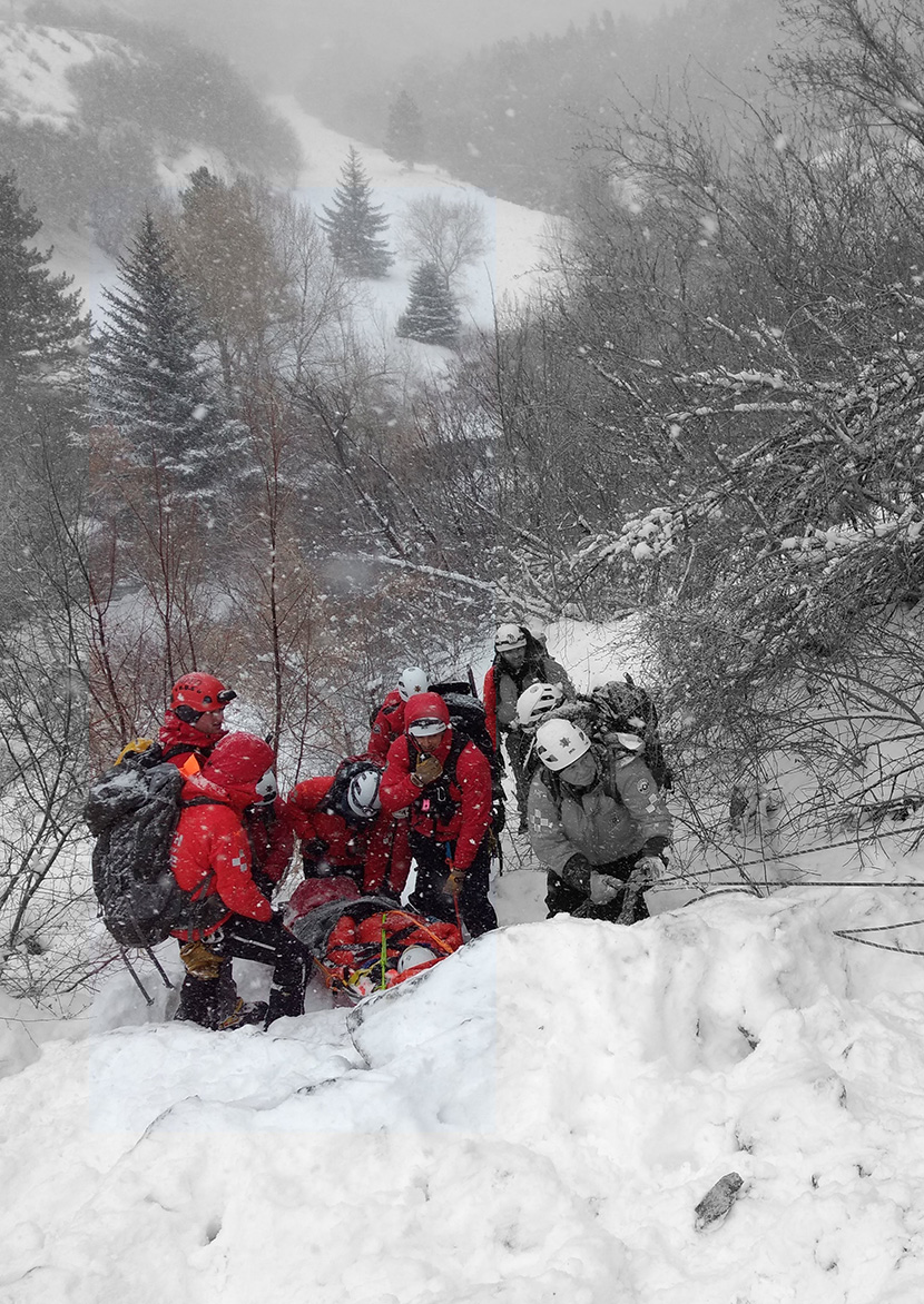Utah County SAR team performing a mountain rescue in winter conditions